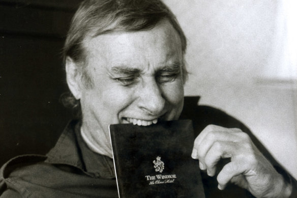 Laying back on his bed at the Windsor Hotel Spike Milligan enjoys the room service.