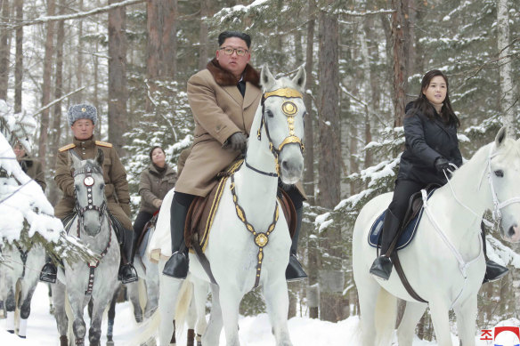 North Korean leader Kim Jong-un, centre, rides on a white horse during his visit to Mount Paektu.