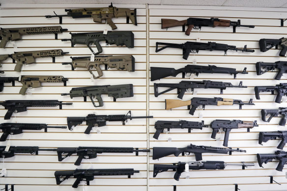 Semi-automatic rifles fill a wall at a gun shop in Lynnwood, Washington.