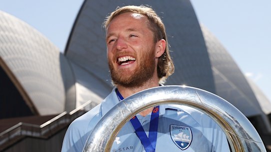 Rhyan Grant poses with the A-League trophy.