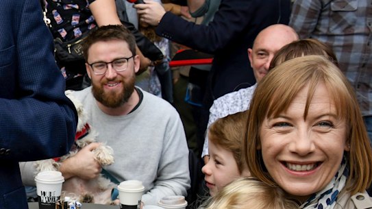 Transport Minister Jo Haylen (right) with Kieren Ash who is sitting with a dog and Prime Minister Anthony Albanese the morning after the federal election last year.