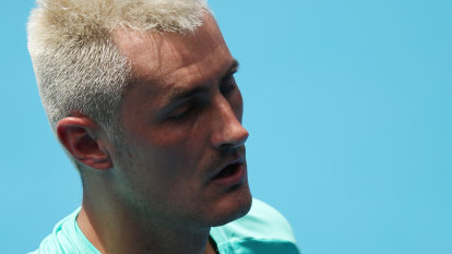 Tomic raising glasses and eyebrows before COVID diagnosis