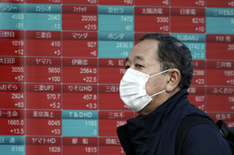 A sea of red is a good thing in Japan: An electronic stock board showing the Nikkei 25 index.