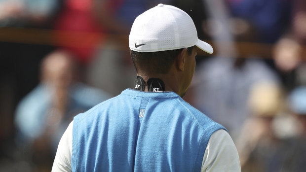 Solid start: Despite visible tape on Tiger Woods' neck, he was content with his opening round.