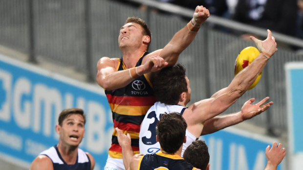 Flying high: Patrick Dangerfield and Daniel Talia battle for the ball last night. 
