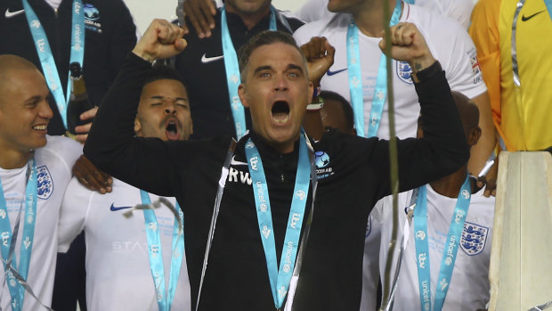 Robbie Williams at Old Trafford, Manchester on Sunday. The singer has been criticised for agreeing to perform at the World Cup's opening ceremony in Russia.