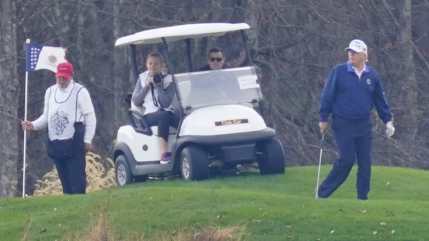 US President Donald Trump, right, plays golf regularly.