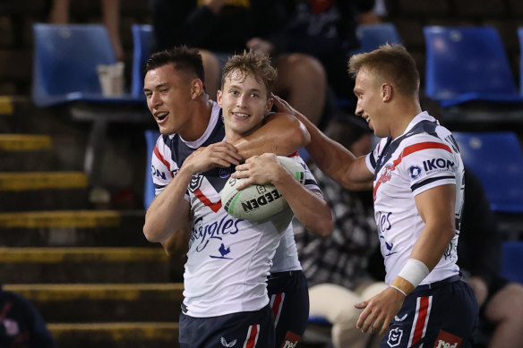Sam Walker (centre) starred as the Roosters put the Knights to the sword.