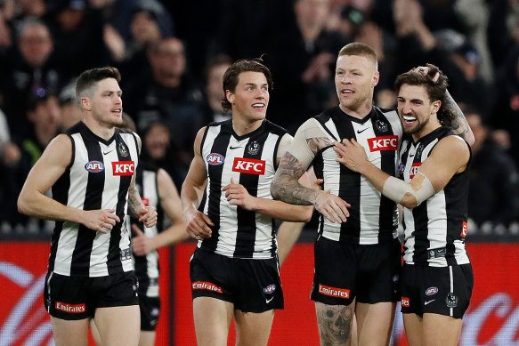 Jordan De Goey (third from left) celebrates a goal with Jack Crisp, Patrick Lipinski and Josh Daicos during Collingwood’s qualifying final defeat.