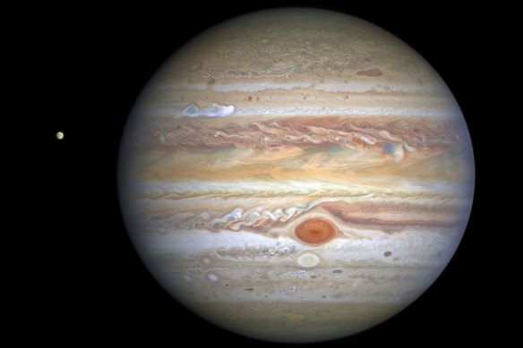 This Aug 25, 2020 image captured by NASA’s Hubble Space Telescope shows the planet Jupiter and one of its moons, Europa, at left.