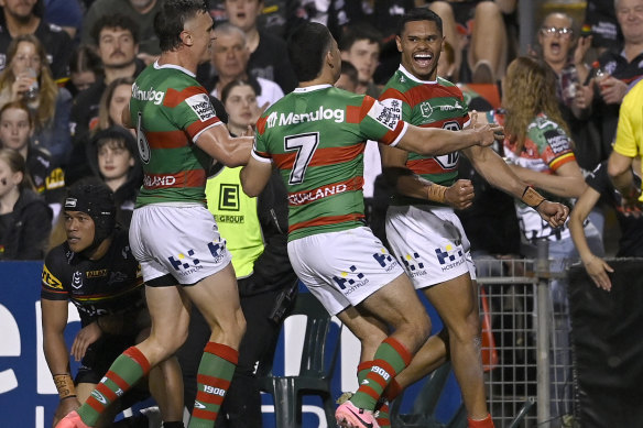 Tyrone Munro is surrounded by teammates after scoring for Souths against the Panthers.