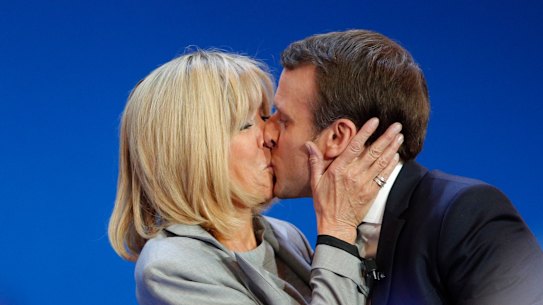 Macron kisses his wife Brigitte on election day in 2017.