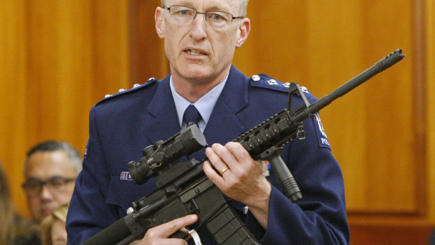 NZ acting police superintendent Mike McIlraith shows MPs in Wellington an AR-15 style rifle similar to one of the weapons a gunman used to slaughter 51 people at two Christchurch mosques in March.