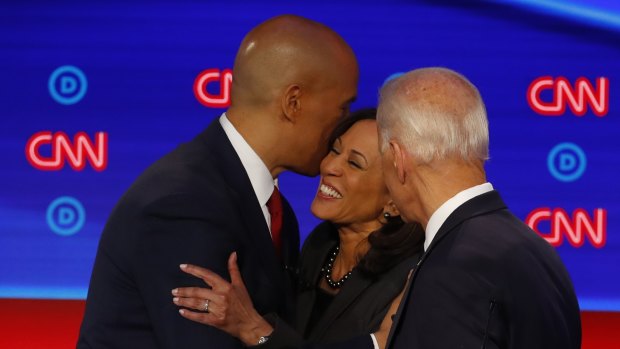 Cory Booker, Joe Biden and Kamala Harris talk after the second of two Democratic presidential primary debates.