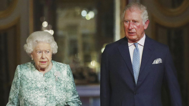Queen Elizabeth II and Prince Charles arrive for the formal opening of the Commonwealth Heads of Government Meeting in the ballroom at Buckingham Palace in London on Thursday.