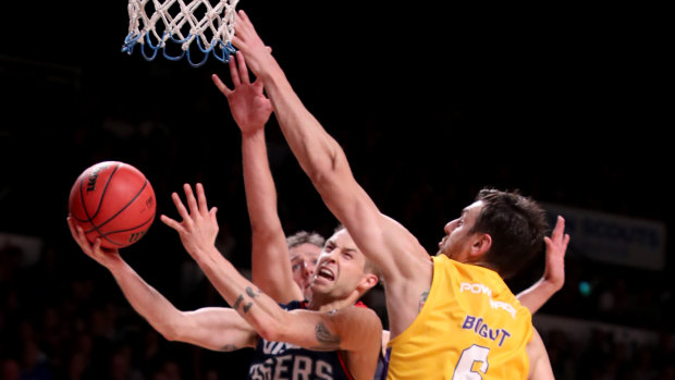 Drive to the basket: Nathan Sobey of the 36ers tries to get past Andrew Bogut.