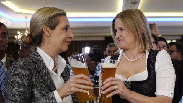 Alice Weidel, left, and Katrin Ebner-Steiner toast with beer at the election party of the Alternative for Germany, AfD, in Mamming, southern Germany, on Sunday.
