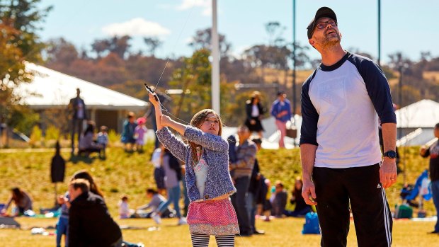 Dan and Poppy Fasch, of Googong, try their hand at kite flying at the Flying High event in Googong.