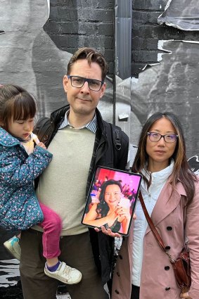 Canadian Michael Kovrig holding up a photo of Cheng Lei in Washington this week. 