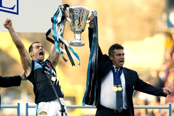 Port Adelaide’s then-skipper Tredrea and coach Mark Williams accept the 2004 premiership cup.