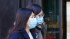 Pedestrians wearing protective face masks in central London.