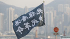 Protesters wave a flag reading "Liberate Hong Kong, the Revolution of Our Times" during a march on Sunday.