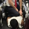 ‘What a bloody flight!’ Passenger pinned down by staff onboard Qantas flight