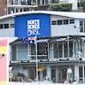 Surfers emerge from the water on Bondi Beach on Friday with North Bondi RSL Club in the background.