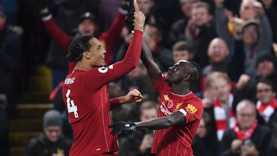 Sadio Mane (right) celebrates Liverpool's third goal on an emphatic night for the Reds.
