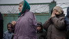 People evacuated from Avdiivka gather to receive food and medicine in Ocheretyne, Ukraine, Feb. 13, 2024.
