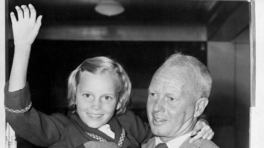 Hollywood director John Farrow carries his daughter Mia, aged 9, out of hospital after a 1954 polio scare.