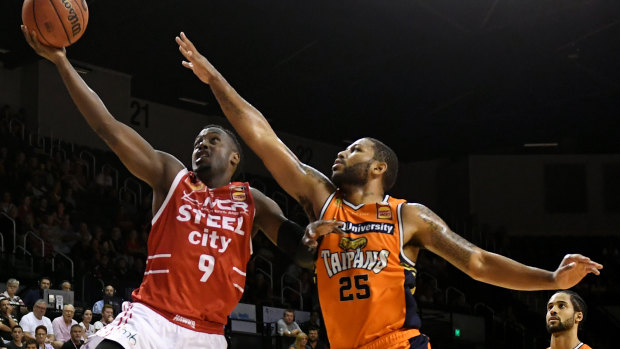 Still alive: Cedric Jackson (left) helped the Hawks to a crucial win over Cairns.