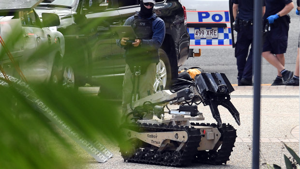 A police bomb squad robot is deployed at the Coronation Drive siege.