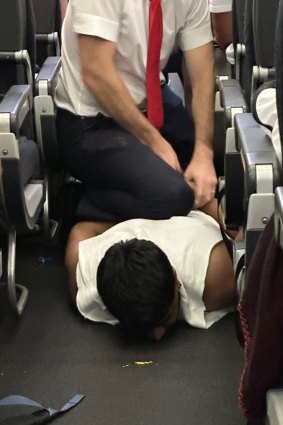 A passenger is restrained on a Bali to Melbourne flight.