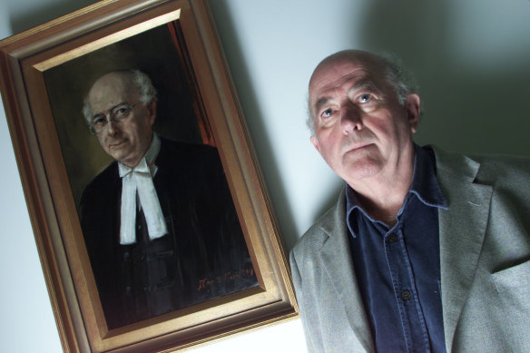 Ian Barker QC in front of his  painted portrait at 53 Martin Place.