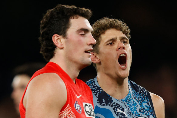 Charlie Curnow celebrates as opponent Tom McCartin gathers himself.