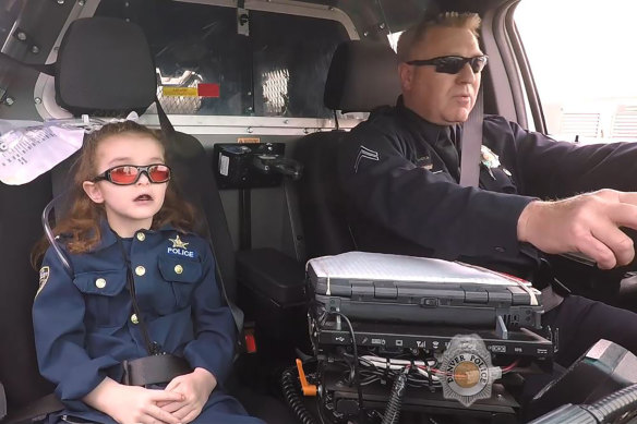 Olivia Gant, who was 6 years old at the time, rides with Captain Tim Scudder on a call in Denver.