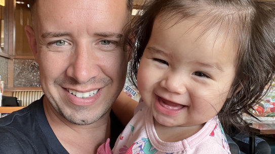 Australian father Daniel White and his child Yui.  