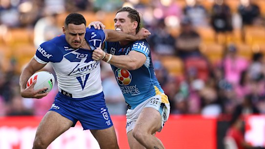 Jacob Kiraz of the Bulldogs is tackled during the round nine NRL match between the Gold Coast Titans and Canterbury Bulldogs at Suncorp Stadium.