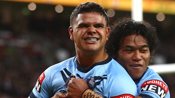 Latrell Mitchell celebrates his try on Sunday night.
