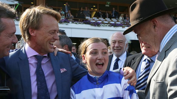 Harlem connections celebrate with Jamie Kah and trainer David Hayes (in hat). 