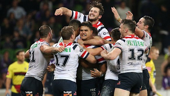Mitchell (centre) is mobbed by teammates after the final play.