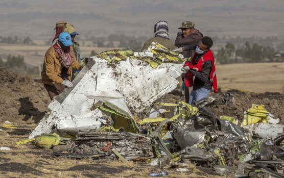 Rescuers at the scene of the Ethiopian Airlines crash. What role in the MAX disaster did Boeing’s directors play?