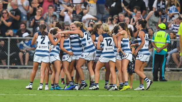 Cats players celebrate a nail-biting win over Collingwood in round one.