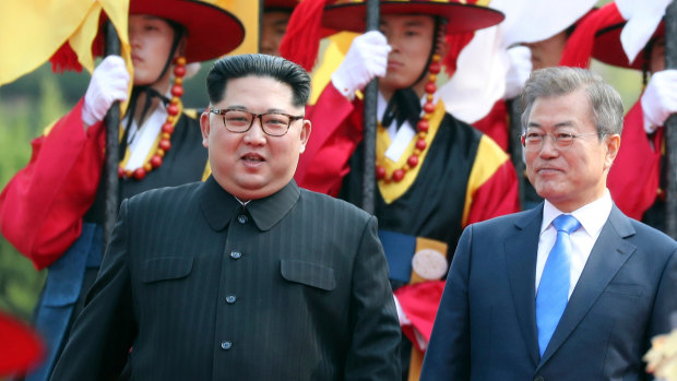North Korean leader Kim Jong-un, left, and South Korean President Moon Jae-in walk together through a honour guard at the border village of Panmunjom in the Demilitarized Zone. 