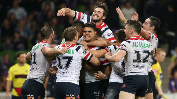 Mitchell (centre) is mobbed by teammates after the final play.