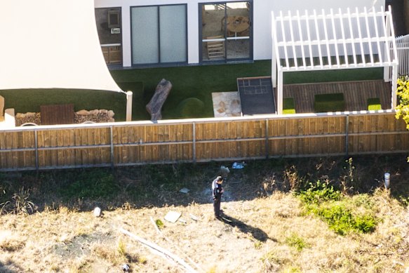 Forensic officer gather evidence at a vacant block behind Play to Learn Castle Hill. 