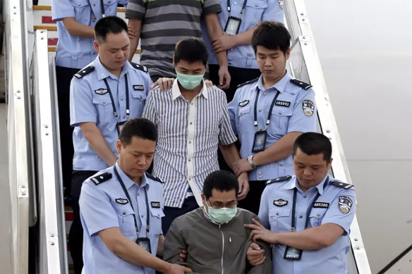 The long reach of Operation Fox Hunt ... these men are among six accused fugitives taken back to China under escort from Indonesia in June 2015.