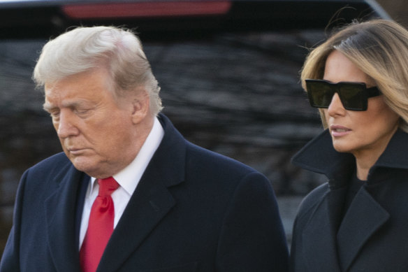 Millions will lose unemployment relief immediately if US President Donald Trump, pictured with first lady Melania on December 23, does not sign the pandemic relief bill this weekend. 