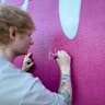 Ed Sheeran signing a mural in Ipswich, Queensland. 